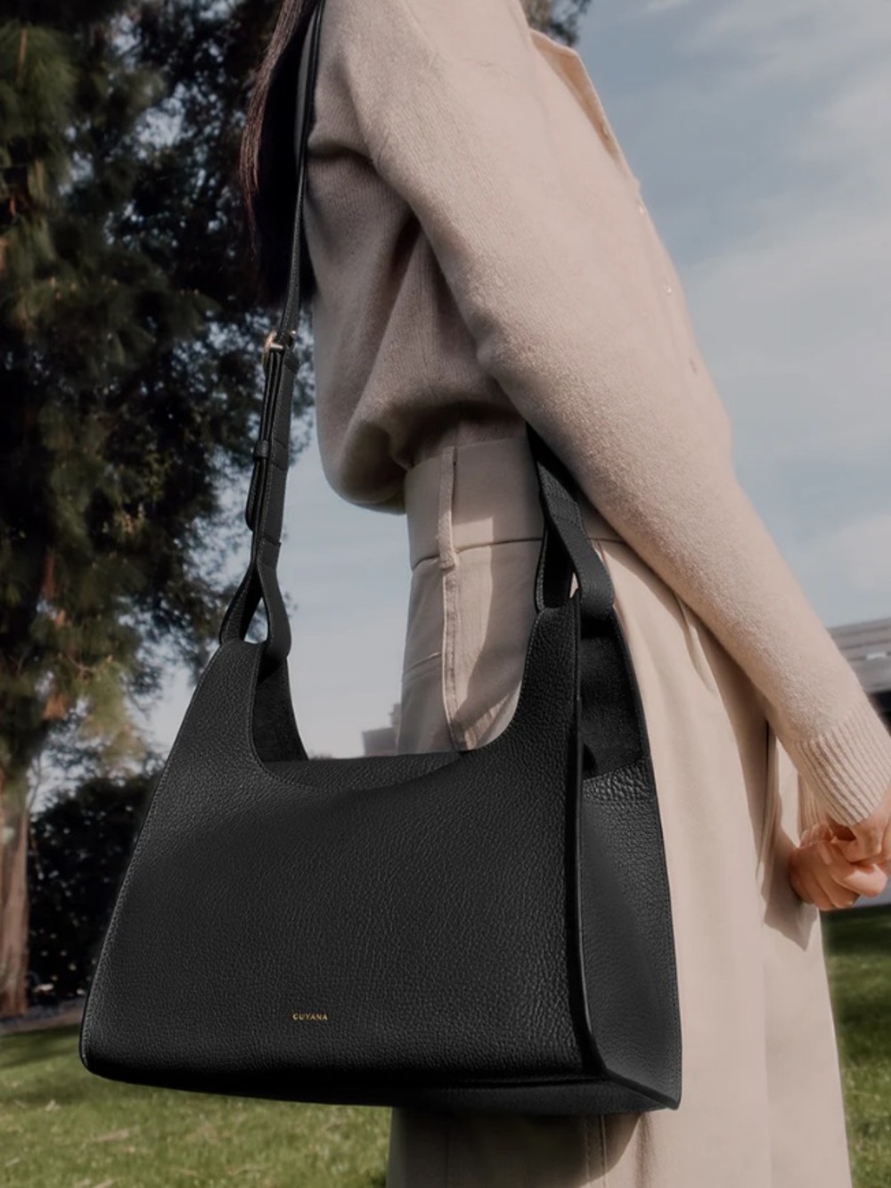Cuyana double loop crossbody bag in black pebble leather and gold hardware